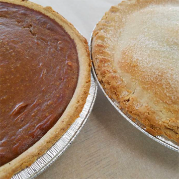 Fresh pumpkin and apple pies with flakey golden crusts